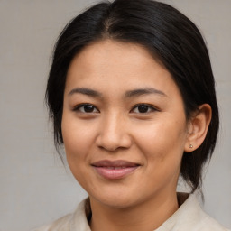 Joyful asian young-adult female with medium  brown hair and brown eyes