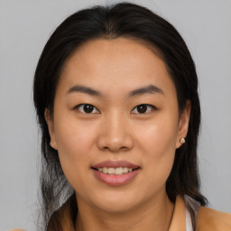 Joyful asian young-adult female with medium  brown hair and brown eyes