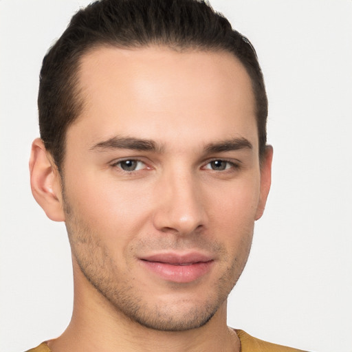 Joyful white young-adult male with short  brown hair and brown eyes