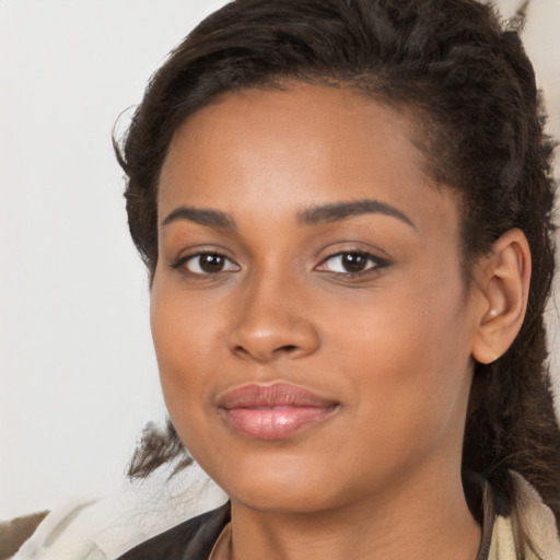 Joyful latino young-adult female with long  brown hair and brown eyes