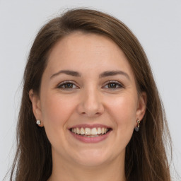 Joyful white young-adult female with long  brown hair and grey eyes