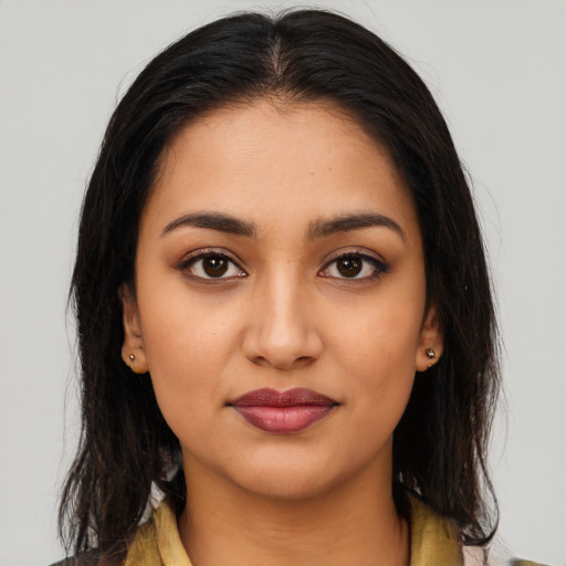 Joyful latino young-adult female with long  brown hair and brown eyes