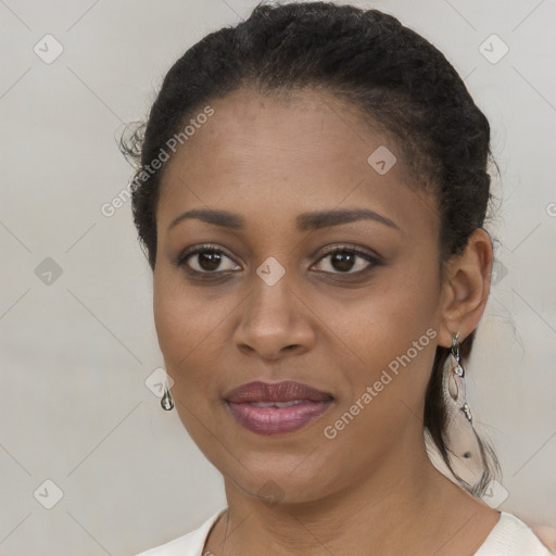 Joyful black young-adult female with short  brown hair and brown eyes