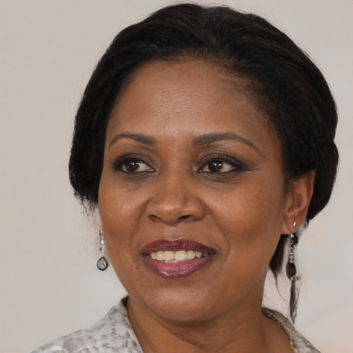 Joyful black adult female with medium  brown hair and brown eyes