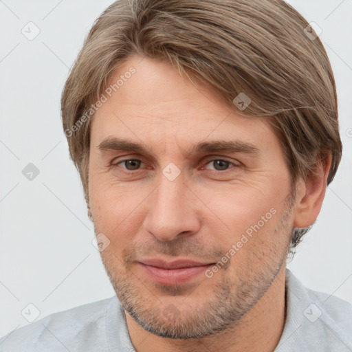 Joyful white adult male with short  brown hair and brown eyes