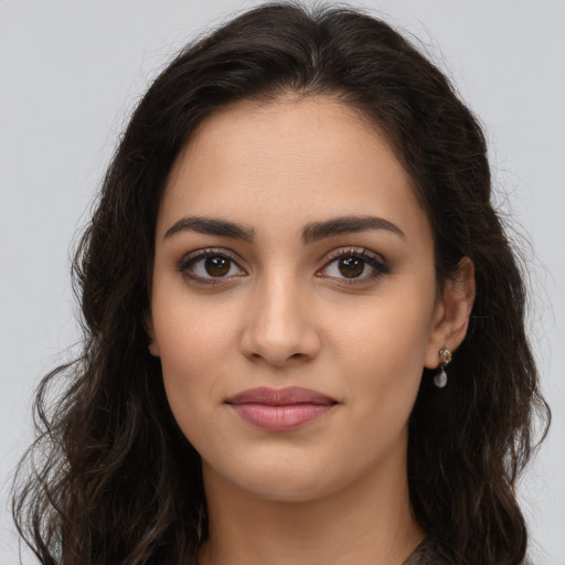 Joyful latino young-adult female with long  brown hair and brown eyes