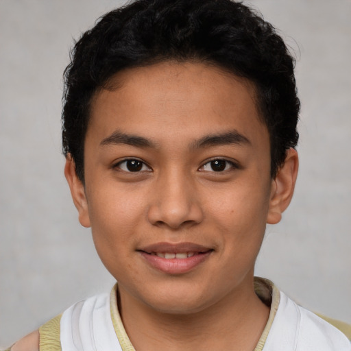 Joyful latino young-adult male with short  brown hair and brown eyes