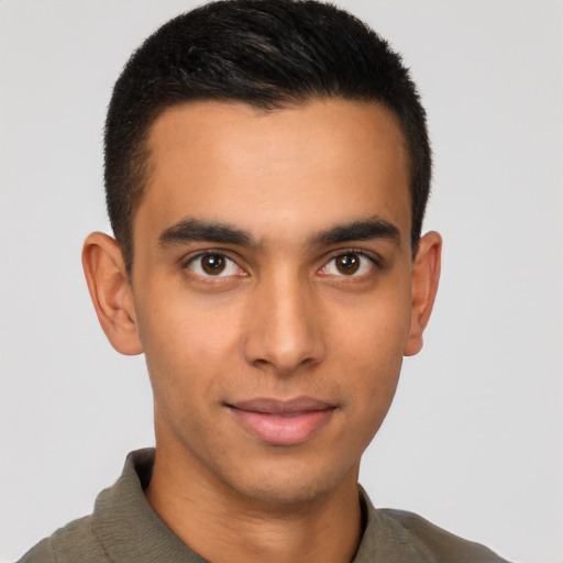 Joyful latino young-adult male with short  brown hair and brown eyes