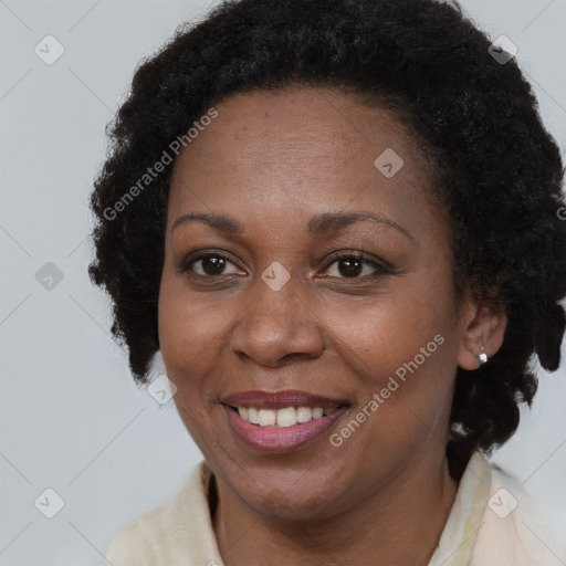 Joyful black adult female with long  brown hair and brown eyes