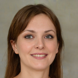 Joyful white young-adult female with medium  brown hair and green eyes