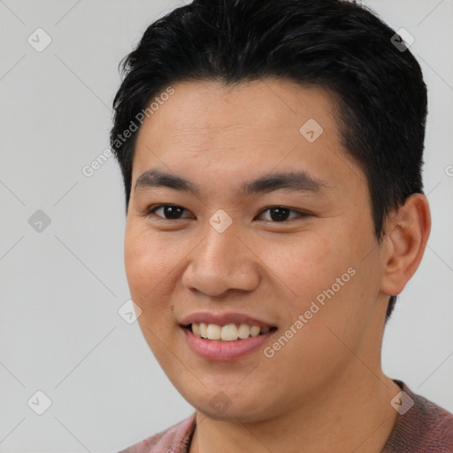 Joyful asian young-adult male with short  black hair and brown eyes