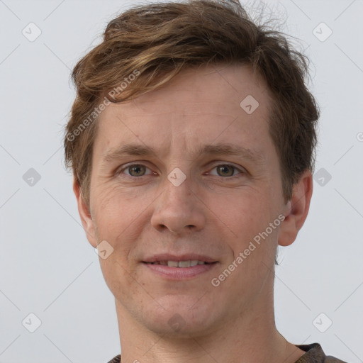 Joyful white adult male with short  brown hair and grey eyes