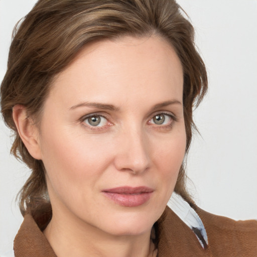 Joyful white young-adult female with medium  brown hair and grey eyes