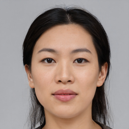 Joyful asian young-adult female with medium  black hair and brown eyes