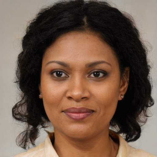 Joyful black young-adult female with medium  brown hair and brown eyes