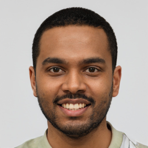 Joyful black young-adult male with short  black hair and brown eyes