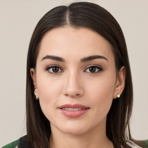 Joyful white young-adult female with long  brown hair and brown eyes