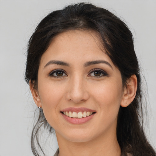 Joyful white young-adult female with long  brown hair and brown eyes