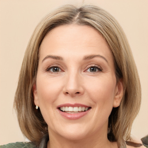 Joyful white adult female with medium  brown hair and brown eyes