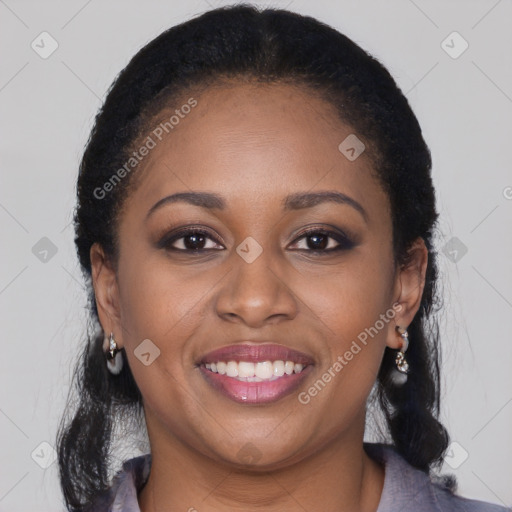 Joyful black young-adult female with long  brown hair and brown eyes