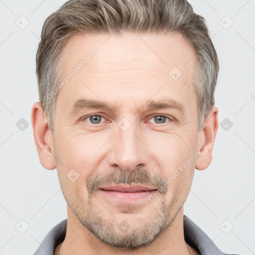 Joyful white adult male with short  brown hair and grey eyes