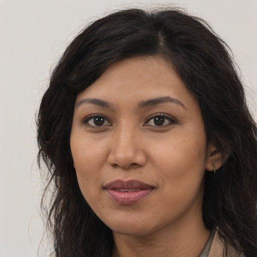 Joyful asian young-adult female with long  brown hair and brown eyes