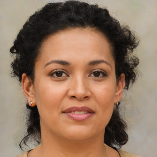 Joyful latino young-adult female with medium  brown hair and brown eyes