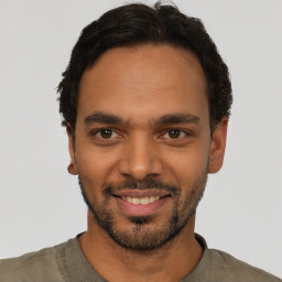 Joyful latino young-adult male with short  black hair and brown eyes