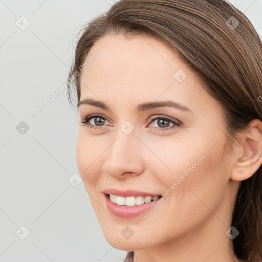 Joyful white young-adult female with long  brown hair and grey eyes