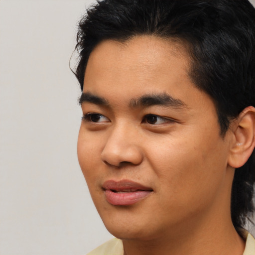 Joyful asian young-adult male with short  black hair and brown eyes