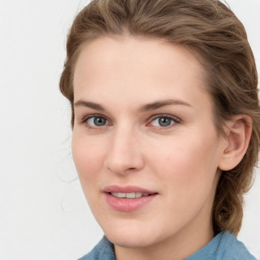 Joyful white young-adult female with medium  brown hair and blue eyes