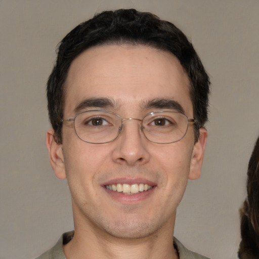 Joyful white adult male with short  brown hair and brown eyes