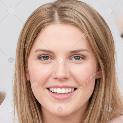 Joyful white young-adult female with long  brown hair and grey eyes