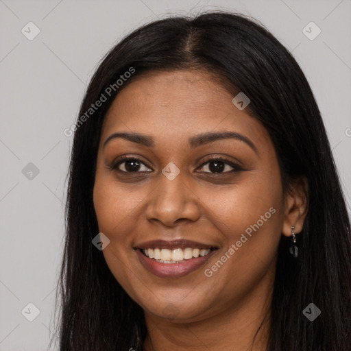 Joyful black young-adult female with long  brown hair and brown eyes