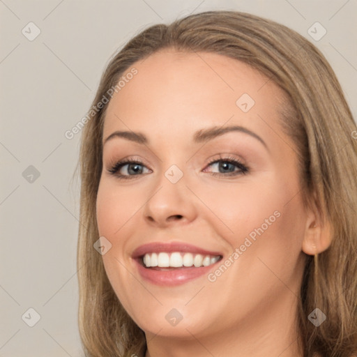 Joyful white young-adult female with long  brown hair and green eyes