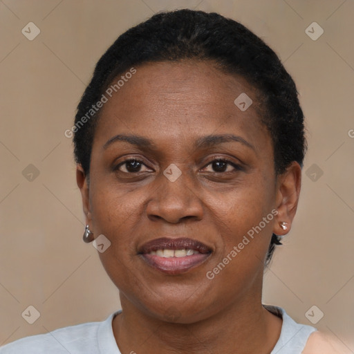 Joyful black adult female with short  brown hair and brown eyes