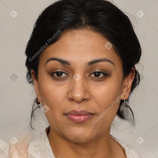 Joyful latino adult female with medium  brown hair and brown eyes