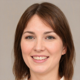 Joyful white young-adult female with medium  brown hair and green eyes