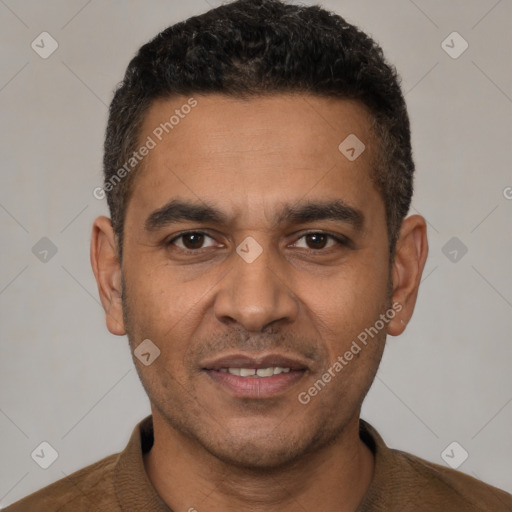 Joyful white adult male with short  black hair and brown eyes