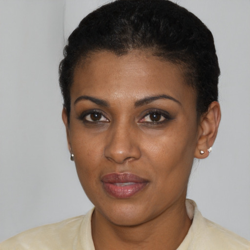 Joyful black young-adult female with short  brown hair and brown eyes