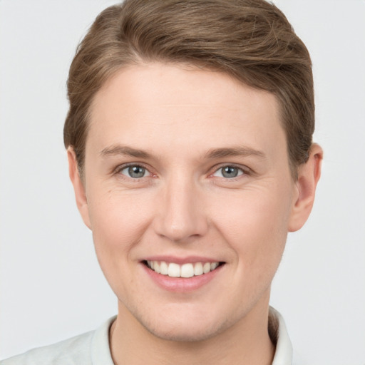 Joyful white young-adult female with short  brown hair and grey eyes