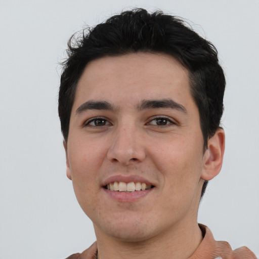 Joyful white young-adult male with short  black hair and brown eyes