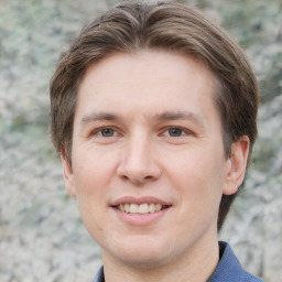 Joyful white adult male with short  brown hair and grey eyes