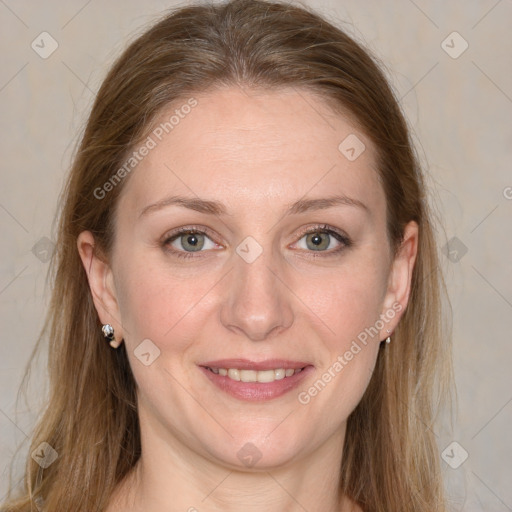 Joyful white adult female with long  brown hair and grey eyes