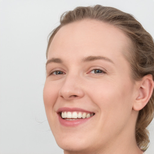 Joyful white young-adult female with medium  brown hair and blue eyes