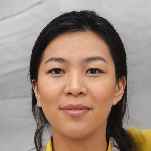 Joyful asian young-adult female with medium  black hair and brown eyes