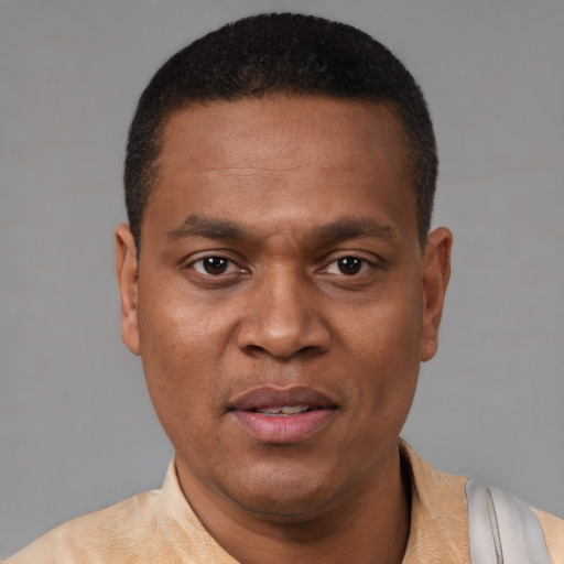 Joyful latino adult male with short  black hair and brown eyes