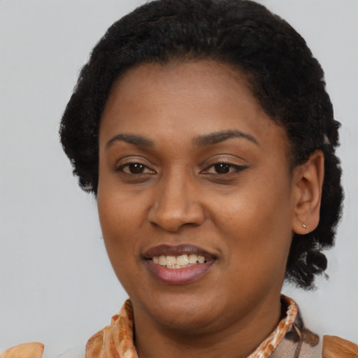 Joyful black young-adult female with short  brown hair and brown eyes