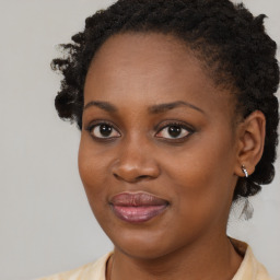 Joyful black young-adult female with medium  brown hair and brown eyes