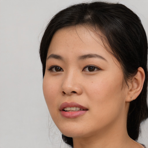 Joyful asian young-adult female with medium  brown hair and brown eyes